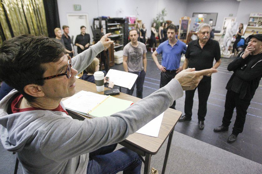 Director Todd Nielsen has a chat with his cast during “Singin’ in the Rain” rehearsals. — Hayne Palmour IV